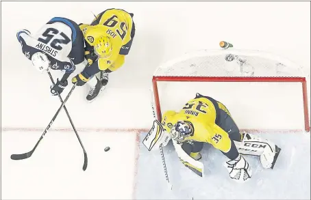  ?? MARK HUMPHREY – THE ASSOCIATED PRESS ?? Winnipeg’s Paul Stastny, left scores a goal between Nashville defenseman Roman Josi (59) and goalie Pekka Rinne during the first period of Thursday’s game.