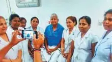  ??  ?? ■ Nurses pose for a picture with RJD President Lalu Prasad at the Rajendra Institute of Medical Sciences (RIMS), Ranchi, where he is currently undergoing treatment.