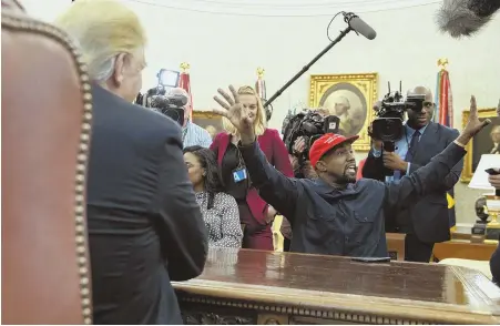  ?? AP PHOTOS ?? I DON’T LOVE IT: Rapper Kanye West, wearing a MAGA hat, meets with President Trump yesterday. West, below, shows Trump a photograph of a hydrogen plane and sits with former football player Jim Brown, bottom.