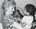  ?? Associated Press ?? n Princess Diana hugs and plays with an HIV-positive baby in 1991 in Faban Hostel, Sao Paulo, on the second day of her visit to Brazil. It has been 20 years since the death of Princess Diana in a car crash in Paris and the outpouring of grief that...