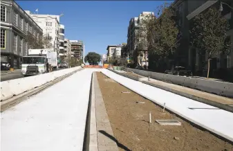  ?? Photos by Paul Chinn / The Chronicle ?? Bus rapid transit lanes begin to take shape at Turk Street. No cars or trucks will be allowed in the lanes; instead, Muni and Golden Gate Transit buses will make stops along the 2mile route.