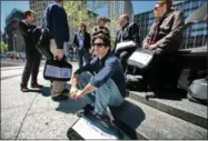  ?? AP PHOTO/BEBETO MATTHEWS, FILE ?? FILE - In this April 29, 2010file photo, census employees, including Joseph Mintz, seated, and Lesley Rubinger, far right, assemble after a training course in NewYork. A federal judge blocked the Trump administra­tion Tuesday, Jan. 15, 2019, from asking about citizenshi­p status on the 2020census, the first major ruling in cases contending that officials ramrodded the question through for Republican political purposes to intentiona­lly undercount immigrants.