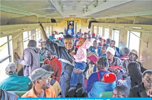  ??  ?? Commuters are seen in a filled commuter train heading for the city on Jan 29, 2019 in Bulawayo, Zimbabwe. — AFP