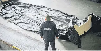  ?? ?? A Bulgarian customs officer inspects a dinghie found at Kapitan Andreevo border checkpoint.