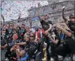  ?? SETH WENIG — THE ASSOCIATED PRESS ?? The U.S. women’s soccer team, Megan Rapinoe center, celebrates at City Hall after a ticker tape parade Wednesday in New York. The U.S. national team beat the Netherland­s 2-0 to capture a record fourth Women’s World Cup title.