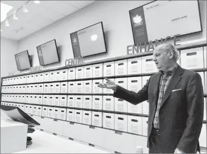  ?? CP PHOTO ?? Nova Scotia Liquor Corp. president and CEO Bret Mitchell gestures during a media tour of a cannabis section at one of its stores in Halifax on Wednesday.