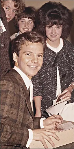  ??  ?? Teenage star: Bobby Vee signs autographs for fans in 1962
