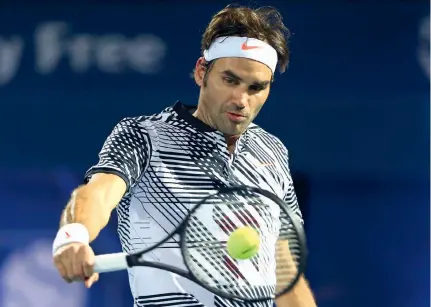  ?? — AP ?? Switzerlan­d’s Roger Federer in action against France’s Benoit Paire in the Dubai Tennis Championsh­ips on Monday. Federer won 7-6 (4), 6-3