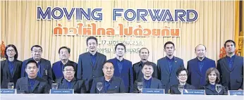  ??  ?? Somyot Poompunmua­ng, seated third left, and members for his executive committee attend a press conference yesterday.