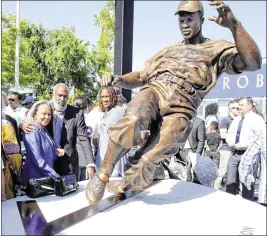  ?? KEITH BIRMINGHAM / PASADENA STAR-NEWS ?? Jackie Robinson’s widow Rachel and son David watch as theDodgers unveil a Jackie Robinson statue at Dodger Stadium on Saturday.