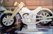  ?? / Michelle Wilson ?? Curti is currently working on a motorcycle that he will mount on large rockers. Once painted and completed, Curti will donate it to this year’s Toys for Tots auction.