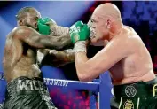  ?? AP ?? Tyson Fury (right) of England lands a right to Deontay Wilder during a WBC heavyweigh­t championsh­ip boxing match in Las Vegas on Saturday. —