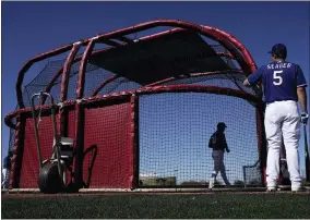  ?? AP PHOTO/CHARLIE RIEDEL ?? Texas Rangers’ Corey Seager waits to bat during spring training baseball practice Monday, Feb. 20, 2023, in Surprise, Ariz.