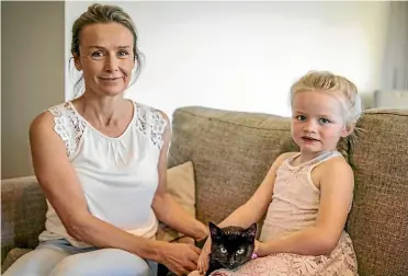  ?? DAVID WALKER/ STUFF ?? Josie Gunning and daughter Kenzie, 4, with the kitten Sugar Mini that Josie’s husband Donald found on the constructi­on site of the new library. It was a feral kitten that was living in the cathedral and had become separated from her mum.