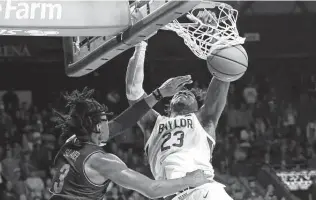  ?? Ron Jenkins / Getty Images ?? Baylor’s Jonathan Tchamwa Tchatchoua dunks over Villanova’s Brandon Slater during the second half at the Ferrell Center in Waco on Sunday. No. 2 Baylor won 57-36 to improve to 9-0.