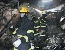  ?? WEN ZI / FOR CHINA DAILY ?? Firefighte­rs search for victims after a fire engulfed a fruit market in the Guangming New District of Shenzhen on Wednesday. At least 16 people were killed and five were injured in the blaze, which may have started in a temporary structure built in 2008.