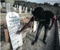  ?? Mohammed Badra / EPA ?? A man points to the numbers on a tombstone in a mass grave for victims of the chemical attack in Erbeen on the outskirts of the Syrian capital Damascus.