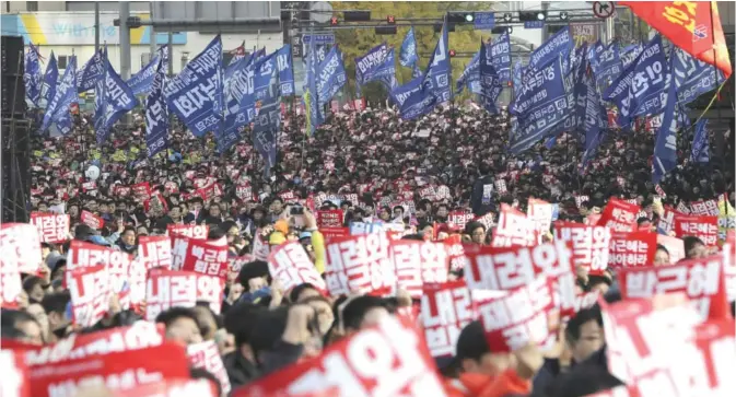  ??  ?? SEOUL: South Korean protesters hold up signs that read “Step down Park Geun-hye” during a rally calling for South Korean President Park Geun-hye to step down yesterday. —AP