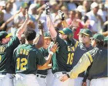  ?? Lacy Atkins / The Chronicle 2001 ?? The A’s Jason Giambi (16) is mobbed after his gamewinnin­g tworun homer against the visiting Yankees on Aug. 12, 2001.