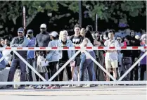  ?? CHRIS TORRES ctorres@star-telegram.com ?? Parents and family line up outside Arlington ISD Athletic Center to be reunited with students following a shooting outside of Bowie High School in Arlington on Wednesday.