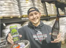  ?? DAX MELMER ?? On Wednesday, Sammy Mclean, a brewer at Walkervill­e Brewery, displays the Geronimo IPA, left, and the Russian Imperial Stout, which both won silver medals at the recent Canadian Brewing Awards.