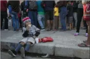  ?? RODRIGO ABD — THE ASSOCIATED PRESS ?? A Central American migrant boy eats a donated breakfast at a temporary shelter in Tijuana, Mexico, early Saturday morning. Many of the nearly 3,000 migrants have reached the border with California. The mayor has called the migrants’ arrival an “avalanche” that the city is ill-prepared to handle.