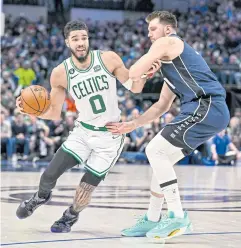  ?? USA TODAY SPORTS ?? The Celtics’ Jayson Tatum, left, is defended by the Mavericks’ Luka Doncic at the American Airlines Center in Dallas.