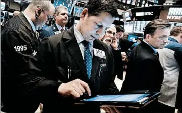  ?? RICHARD DREW/AP ?? Traders react Monday to news that China’s economy grew 6.9 percent in the first quarter.