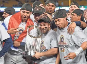  ??  ?? Jose Altuve and the Astros celebrate after winning the World Series against the Dodgers on Wednesday night. JAYNE KAMIN-ONCEA, USA TODAY SPORTS