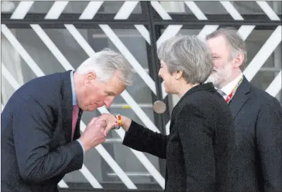  ?? Virginia Mayo ?? The Associated Press European Union chief Brexit negotiator Michel Barnier kisses the hand of British Prime Minister Theresa May as they arrive for an EU summit at the Europa building in Brussels on Friday.