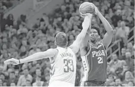  ?? Michael Perez / Associated Press ?? Defense from players like forward Ryan Anderson, left, contesting a shot by Philadelph­ia’s Joel Embiid, helped get the Rockets past the 76ers on Wednesday.