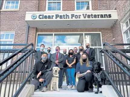  ?? AMY SOKOLOW/LOWELL SUN ?? Nashoba Valley legislator­s and Clear Path for Veterans employees pose outside the Clear Path site in Devens Tuesday which will be a mass coronaviru­s vaccinatio­n site beginning next month.