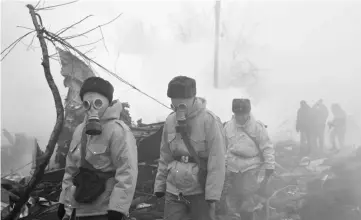  ??  ?? Rescue personnel work at the crash site of a Turkish cargo plane in the village of Dacha-Suu outside Bishkek. — AFP photo