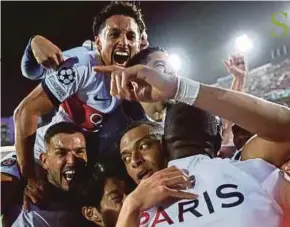  ?? AFP PIC ?? PSG’s Kylian Mbappe (centre) celebrates scoring with teammates during their Champions League quarter-final second leg match at the Estadi Olimpic Lluis Companys in Barcelona on Tuesday.