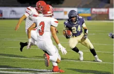  ??  ?? Santa Fe High School’s Sammy Martinez, right, tries to evade Bernalillo’s Damian Gutierrez, rear, and Reyes Ludi-Herrera.