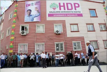  ??  ?? People gather outside the headquarte­rs of pro-Kurdish Peoples’ Democratic Party (HDP) during an election campaign in Diyarbakir.