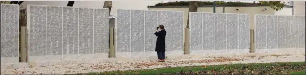  ?? (AP/Lisa Leutner) ?? A woman walks around Tuesday in the Shoah Wall of Names Memorial, which carries the name of every Austrian Jew who fell victim to the Nazis, in Vienna.