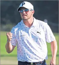  ?? ?? Ewen Ferguson fist-pumps after holing a putt yesterday