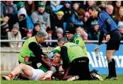  ??  ?? Concern: Mayo’s Lee Keegan is treated for a head injury against Tyrone earlier this year