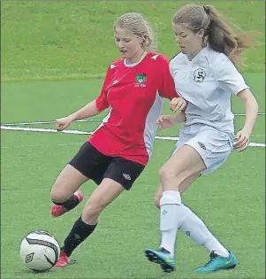  ?? CHARLES REID/THE GUARDIAN ?? Celeste Gaudet, left, of the New Brunswick Canada Games women’s soccer team battles for the ball with Grace Coles of the P.E.I. Canada Games squad in New Brunswick Women’s Premier Soccer League action Saturday in Charlottet­own.