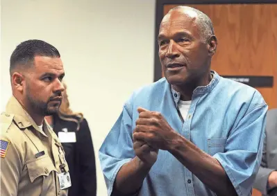  ?? PHOTOS BY JASON BEAN, RENO GAZETTE-JOURNAL, VIA USA TODAY NETWORK ?? O.J. Simpson reacts Thursday after learning he was granted parole in Nevada. He is due to be released Oct. 1.