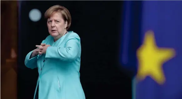  ?? Markus Schreiber / AP ?? German chancellor Angela Merkel waits for Chinese president Xi Jinping, visiting for the G20 meeting, at the chanceller­y in Berlin yesterday