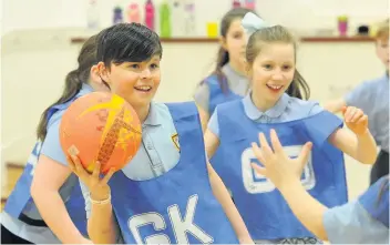  ??  ?? Ball skills The pupils practise their passing technique