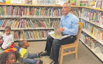  ?? | FRAN SPIELMAN/ SUN- TIMES ?? Mayor Rahm Emanuel reads to children at Altgeld Gardens, which is getting a much bigger library.