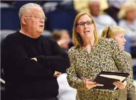  ?? STAFF FILE PHOTO BY ROBIN RUDD ?? Katie Burrows, right, and Jim Foster talk during a UTC women’s basketball game this past season. Foster, the Mocs’ head coach the past five seasons, retired Tuesday, with Burrows taking over the program on an interim basis.