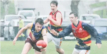  ??  ?? Warragul Industrial­s player Harrison Perry leads his opponent in the race to the ball; Photograph­s: Michael Robinson.