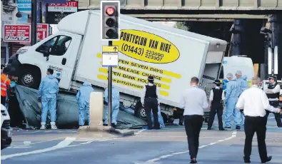  ??  ?? Forensic officers move the van that struck pedestrian­s near two mosques in the Finsbury Park neighbourh­ood in north London early Monday. At least nine people were injured. British media identified the suspect as Darren Osborne, a 47-year-old father of...