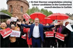  ?? ?? Sir Keir Starmer congratula­tes winning Labour candidates in the Cumberland council election in Carlisle