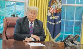  ?? EVAN VUCCI/AP ?? President Donald Trump listens Monday during an Oval Office phone call with Mexican President Enrique Pena Nieto about a trade agreement between the United States and Mexico.