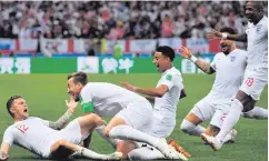  ??  ?? Dream start: England’s defender Kieran Trippier (left) is congratula­ted by his team-mates after scoring the opener